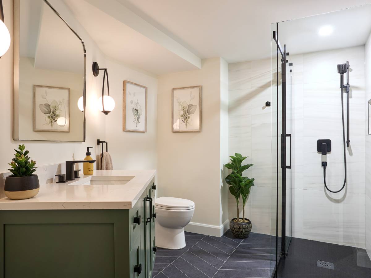 a bathroom with a toilet, sink, and shower