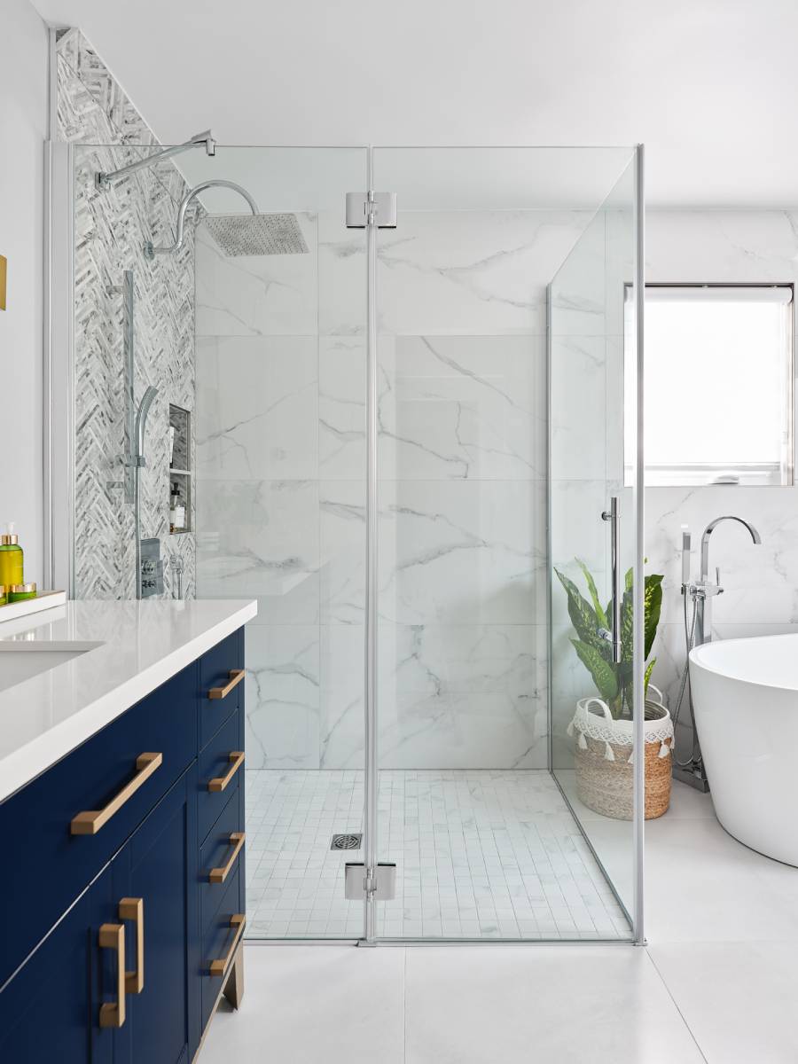 a bathroom with a tub, sink, and shower